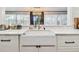 Bright kitchen features farmhouse sink with modern faucet and bright window at 201 Gornto Lake Rd, Brandon, FL 33510