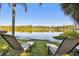 Beautiful lake view from backyard with lawn chairs, providing a serene and relaxing outdoor space at 201 Gornto Lake Rd, Brandon, FL 33510