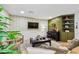 Comfortable living room with a flat screen television, two armchairs, and a cozy green feature wall at 201 Gornto Lake Rd, Brandon, FL 33510