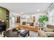 Inviting living room with tan leather sofa, decorative pillows, and a stylish coffee table with decorative items at 201 Gornto Lake Rd, Brandon, FL 33510