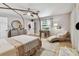 Comfortable main bedroom with stylish bed, a chaise lounge, and large window at 201 Gornto Lake Rd, Brandon, FL 33510
