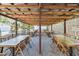 Spacious outdoor seating area featuring multiple tables and chairs under a rustic roof at 201 Gornto Lake Rd, Brandon, FL 33510