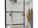 Modern walk-in shower with white subway tile, sleek black fixtures, and a glass enclosure at 201 Gornto Lake Rd, Brandon, FL 33510