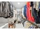 Organized walk-in closet with shelving, hanging racks, and a centered bench for comfortable dressing at 201 Gornto Lake Rd, Brandon, FL 33510