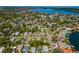 Panoramic aerial view of a quiet residential neighborhood featuring mature trees, well-manicured lawns, and a nearby bay at 208 44Th Ne Ave, St Petersburg, FL 33703
