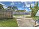 Fenced backyard with a gate, gravel alley, and partial view of the yard at 208 44Th Ne Ave, St Petersburg, FL 33703