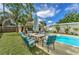 Backyard space with a pool, dining area, and tiki bar that provides ample seating for outdoor enjoyment at 208 44Th Ne Ave, St Petersburg, FL 33703