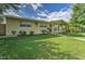 Charming single-story home with a well-maintained lawn, complemented by lush landscaping and mature trees at 208 44Th Ne Ave, St Petersburg, FL 33703