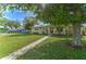 Charming single-story home featuring a well-maintained lawn, mature trees, and a welcoming walkway at 208 44Th Ne Ave, St Petersburg, FL 33703