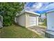 A detached one car garage with siding and a door, located near the pool in the backyard at 208 44Th Ne Ave, St Petersburg, FL 33703