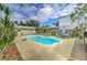 Private backyard oasis with a sparkling pool, lounge chairs, a tiki bar, and lush landscaping, perfect for relaxing at 208 44Th Ne Ave, St Petersburg, FL 33703