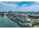 Waterfront condo complex featuring boat docks, swimming pool, and views of the city skyline at 223 Island Way # 5D, Clearwater Beach, FL 33767