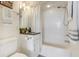 Well-lit bathroom with a shower-tub combo, vanity with granite top, and modern fixtures at 223 Island Way # 5D, Clearwater Beach, FL 33767
