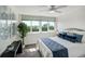Bright bedroom featuring a ceiling fan, plush bedding, and a window offering city views at 223 Island Way # 5D, Clearwater Beach, FL 33767