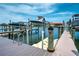 Scenic boat dock featuring boat lifts on the water with beautiful sky and nearby house at 223 Island Way # 5D, Clearwater Beach, FL 33767