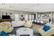 Spacious common area with couches, chairs, tv, and a kitchen in a shared space at 223 Island Way # 5D, Clearwater Beach, FL 33767