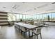 Large, bright common room with ample seating, a long table, and scenic water views at 223 Island Way # 5D, Clearwater Beach, FL 33767