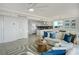 Open-concept living area with a modern kitchen, tile floors, and comfortable seating with stylish decor at 223 Island Way # 5D, Clearwater Beach, FL 33767