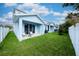Charming patio with green grass and blue building exterior, perfect for outdoor relaxation at 2529 Mario Way, Clearwater, FL 33761
