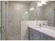 Modern bathroom featuring glass enclosed shower with marble tile, and vanity with light gray cabinets at 2529 Mario Way, Clearwater, FL 33761
