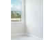 Corner of a bright, naturally lit room with a large window and neutral decor providing a serene space at 2529 Mario Way, Clearwater, FL 33761