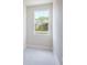 Well-lit room with a large window offering views of trees, enhanced by neutral walls and plush carpet at 2529 Mario Way, Clearwater, FL 33761