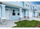 Inviting townhome showcasing a covered porch with stone accented columns at 2529 Mario Way, Clearwater, FL 33761