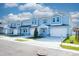 Attractive blue townhouses showcase attached garages, and well-maintained landscaping at 2529 Mario Way, Clearwater, FL 33761