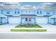 Stunning blue townhomes highlight private garages, stone trim, and tidy lawns, ideal for comfortable living at 2529 Mario Way, Clearwater, FL 33761