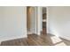 Hallway with hardwood floor leading to a bathroom and kitchen at 2529 Mario Way, Clearwater, FL 33761