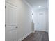 Bright hallway with wood floors and white doors, leading to other rooms at 2529 Mario Way, Clearwater, FL 33761