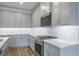 Contemporary kitchen with gray cabinets, stainless steel stove, and white countertops at 2529 Mario Way, Clearwater, FL 33761