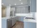 A modern kitchen features gray cabinetry, stainless steel appliances, and ample counter space at 2529 Mario Way, Clearwater, FL 33761