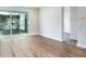 Bright living room with hardwood floor, base molding and sliding glass doors at 2529 Mario Way, Clearwater, FL 33761