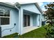 Relax on the covered patio and enjoy the view of the green lawn and landscaping at 2529 Mario Way, Clearwater, FL 33761