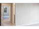 Neutral room showcasing light walls and flooring leading to another bedroom with an exterior view at 2529 Mario Way, Clearwater, FL 33761