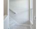 Carpeted staircase with white banister and trim next to a window at 2529 Mario Way, Clearwater, FL 33761