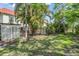 Private backyard with a garden, fence, and lush tropical landscaping at 2700 Bayshore Blvd # 542, Dunedin, FL 34698