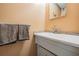 Bathroom featuring a single vanity with tiled backsplash and neutral walls at 2700 Bayshore Blvd # 542, Dunedin, FL 34698