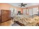 Comfortable bedroom with ceiling fan, dresser and view of trees at 2700 Bayshore Blvd # 542, Dunedin, FL 34698