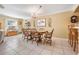 Open dining area featuring tiled floors, natural light, and a chandelier at 2700 Bayshore Blvd # 542, Dunedin, FL 34698