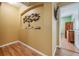Hallway features wood floors and stylish decor niche and closet at 2700 Bayshore Blvd # 542, Dunedin, FL 34698