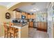 Bright kitchen featuring wood cabinetry, granite counters, and stainless steel appliances at 2700 Bayshore Blvd # 542, Dunedin, FL 34698
