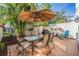 Private patio area perfect for outdoor dining featuring a dining table, umbrella, and outdoor seating at 2700 Bayshore Blvd # 542, Dunedin, FL 34698