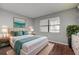 Bright bedroom with a plush bed, accent pillows, and a tranquil view from the window at 2971 Estancia Blvd # 328, Clearwater, FL 33761