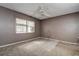 Bright bedroom features a window, carpet, and ceiling fan at 2971 Estancia Blvd # 328, Clearwater, FL 33761