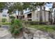 A serene garden view of the condo building with a peaceful landscape and covered balcony at 2971 Estancia Blvd # 328, Clearwater, FL 33761