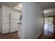 View of galley kitchen looking into living area, featuring white cabinets and appliances at 2971 Estancia Blvd # 328, Clearwater, FL 33761