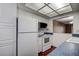 Efficient kitchen features white appliances, ample cabinet space, and recessed lighting at 2971 Estancia Blvd # 328, Clearwater, FL 33761
