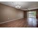 Empty living room with a ceiling fan and sliding glass door to the balcony at 2971 Estancia Blvd # 328, Clearwater, FL 33761